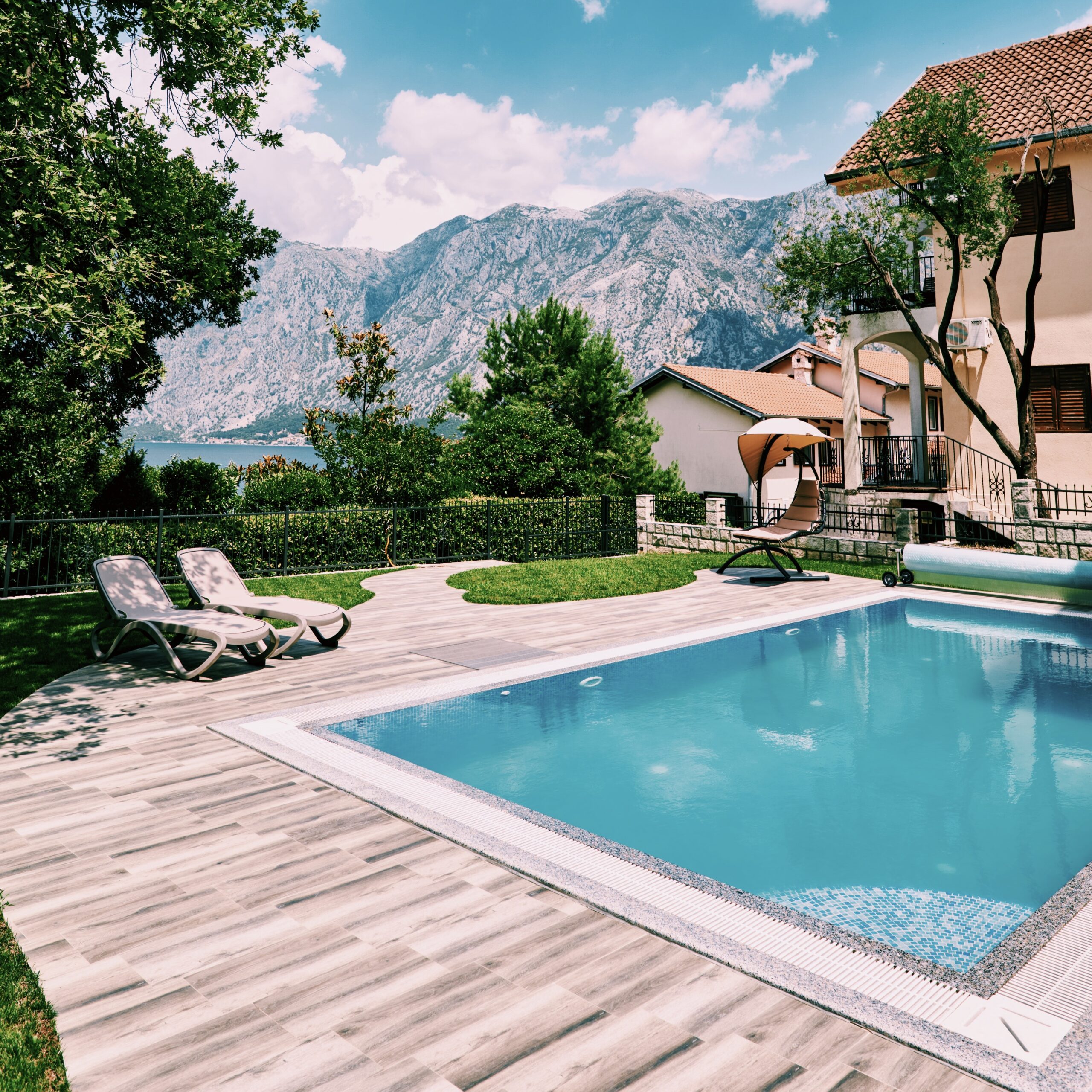 Swimming pool in the courtyard of the house with sun loungers and mountain views. High quality photo Processed with VSCO with c1 preset